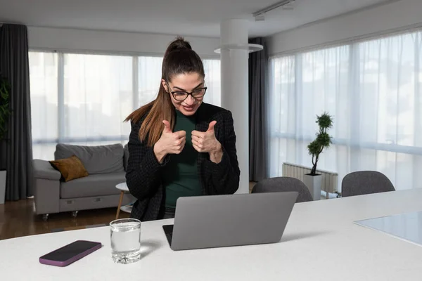 Online conference. Intelligent business woman using laptop making video call to business partner. Home office. Smart expert female working from home at computer for telecommunication.