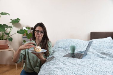 Genç tembel iş kadını işe gitmek zorunda kalmasın diye arayıp hasta olduğu yalanını söyledi. Evde kalıp boş gününün tadını çıkarmak istedi. Kadın hasta numarası yapar, bu yüzden çalışmaz..