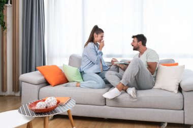 Young happy couple man and woman celebrate after she had pregnancy test and test is positive. Pregnant girl hugging her boyfriend from happiness after she find out that they will have a baby.