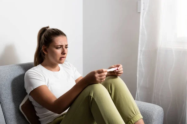 Young Nervous Woman Sitting Home Holding Pregnancy Test Impatiently Waiting — Foto Stock