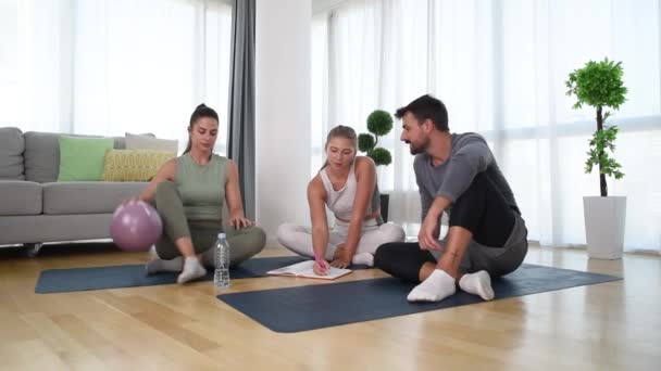 Young Woman Fitness Yoga Instructor Helping Couple Home Workout Exercises — 图库视频影像