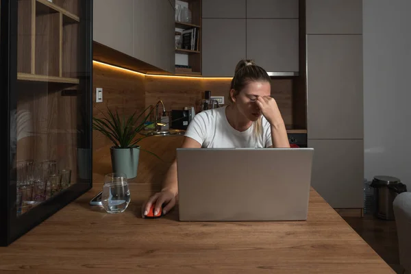 Exhausted woman suffering from severe headache massaging eyes having tension or strain, tired overworked female experience blurry vision of dizziness after long working at laptop. Fatigue concept