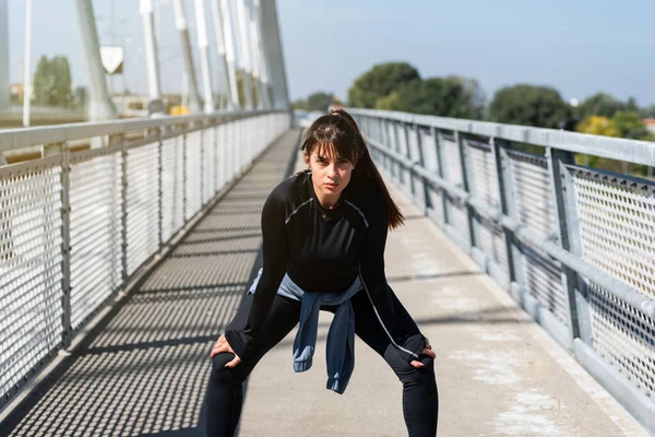 Young woman cancer survivor decides to change her way of life after illness and start practicing every morning as new life routine. Female workout training outdoor for health and happiness.