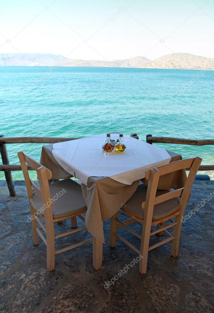 Greek outdoor restaurant with Mediterranean sea view(Crete, Greece)