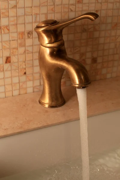 Closeup of shiny brass faucet — Stock Photo, Image