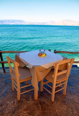 greek outdoor restaurant with Mediterranean sea view(Crete, Gree clipart