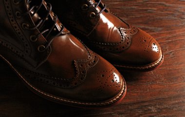 luxury brown shoes on wood background clipart