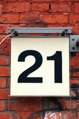Number 21 on red brick wall
