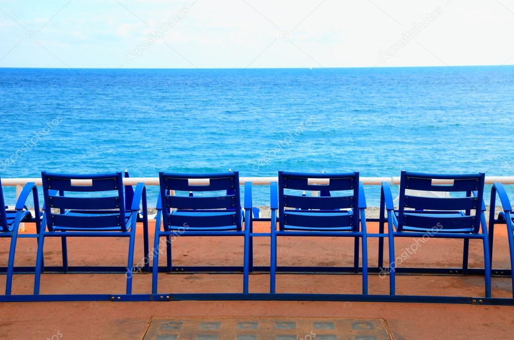 Blue empty chairs on Promenade des Anglais, Nice, France