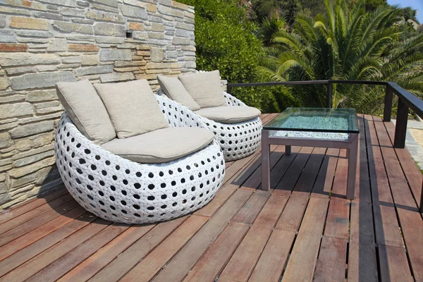 White outdoor furniture on wood resort terrace — Stock Photo, Image
