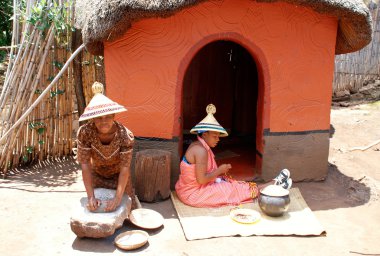Sotho women at tribal house in Lesedi Cultural Village,South Afr clipart