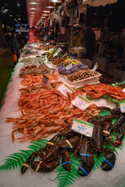 Barselona, İspanya - 23 Kasım 2021: Mercat de la Boqueria, İspanya 'da bir pazarda taze balık ve deniz ürünleri satılıyor