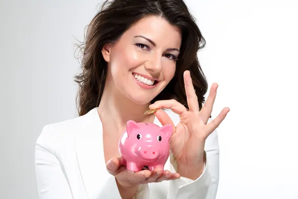 Young beautiful woman standing with piggy bank money box — Stock Photo, Image