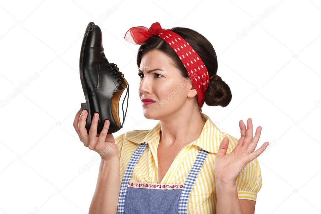 beautiful vintage housekeeper holding a smelly shoes with facia