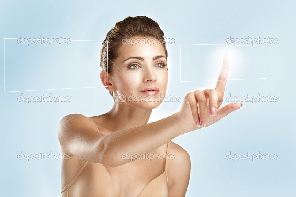 young beautiful model touching a futuristic screen panel
