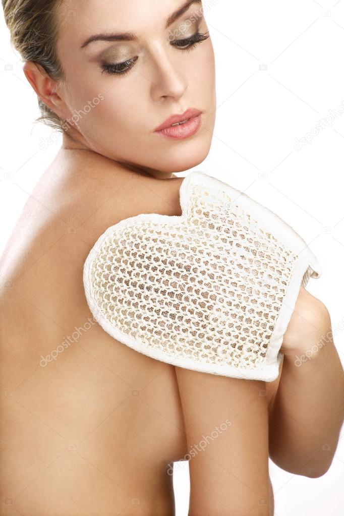 close up of a beautiful woman using a scrub glove