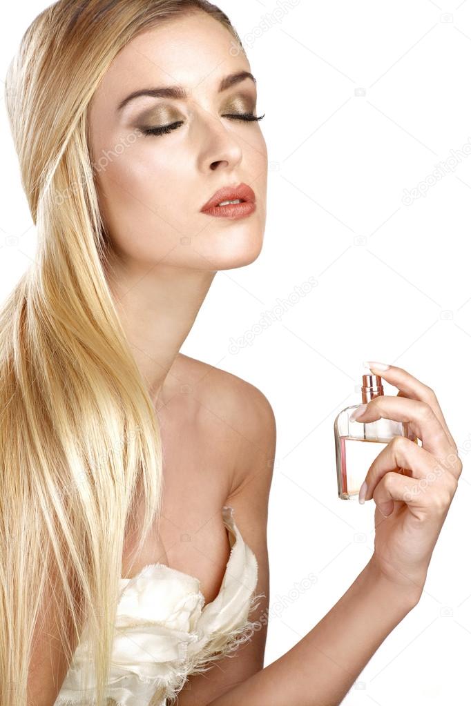 elegant woman applying perfume on her body