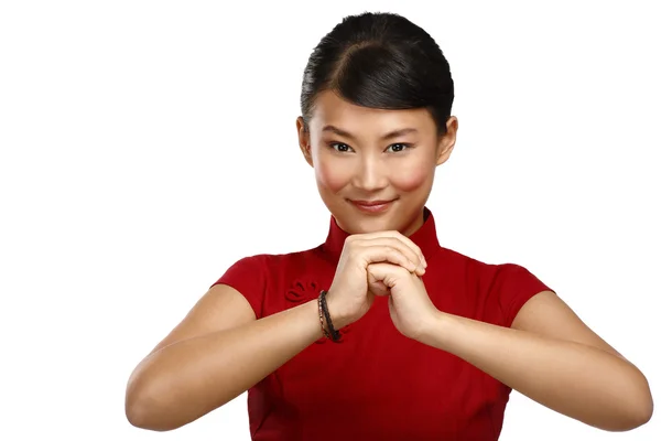 Chinese woman greeting gesture in elegant red dress — Stock Photo, Image