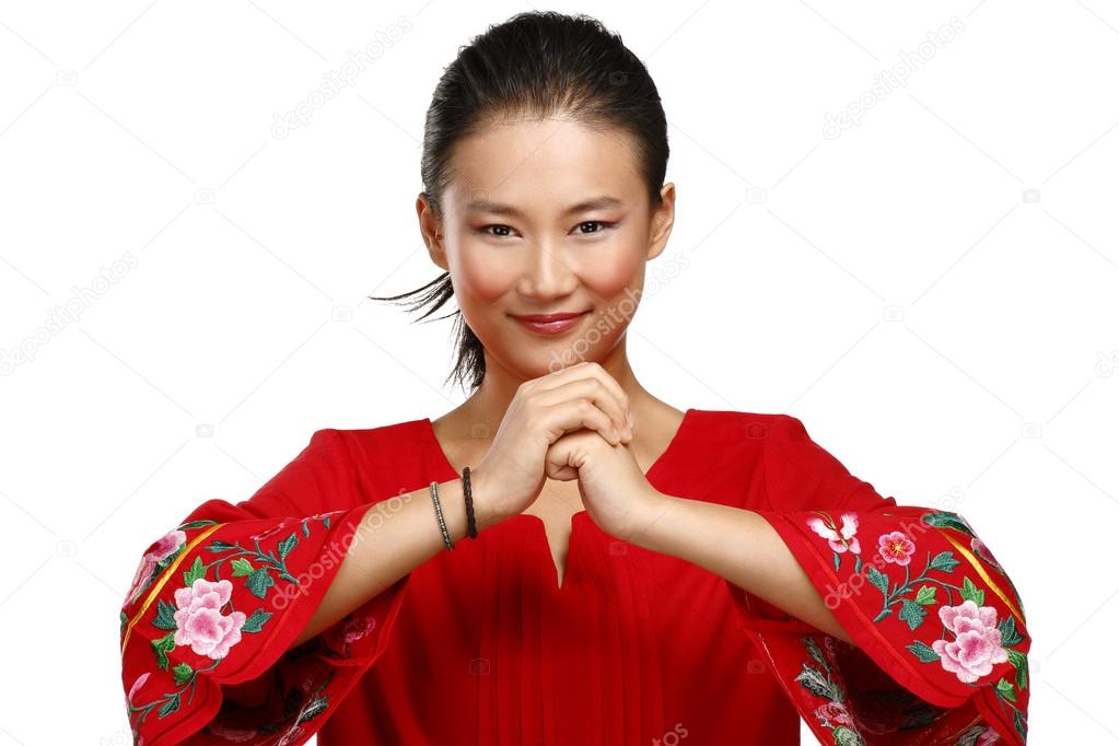 Chinese woman greeting gesture in elegant red dress