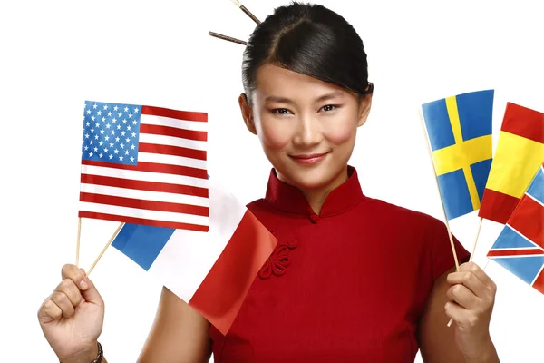 Beautiful asian woman showing multicolor international flags — Stock Photo, Image