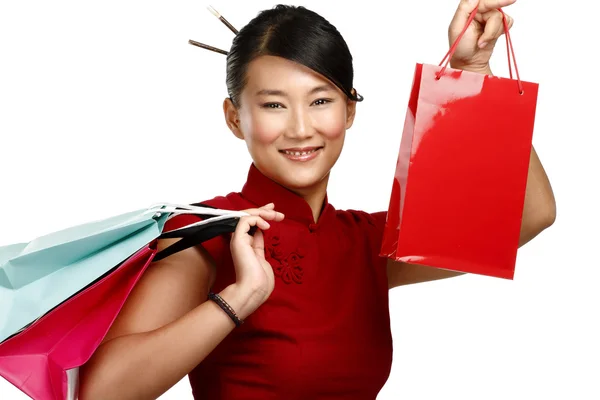 Schöne asiatische Frau zeigt bunte Einkaufstüten — Stockfoto