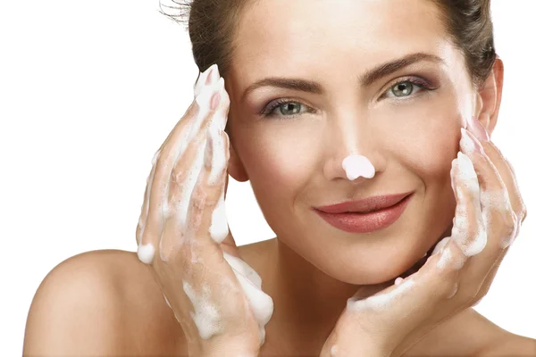Bella donna che si pulisce il viso con un trattamento di schiuma — Foto Stock