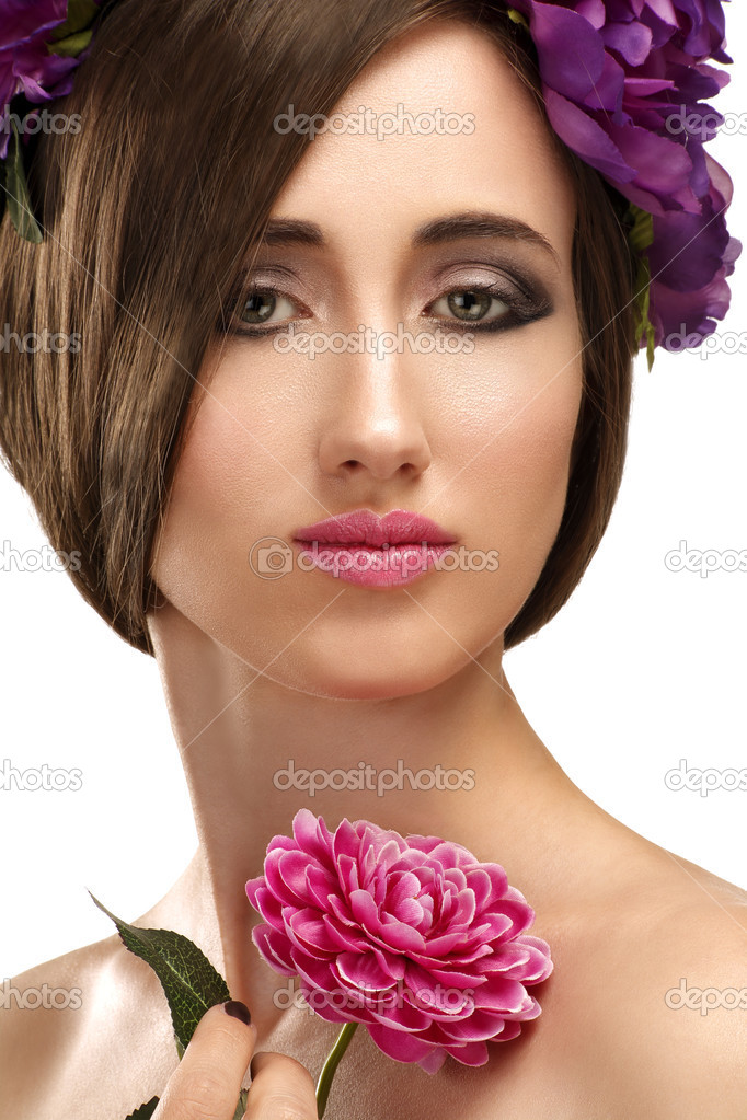 Beautiful girl with violet flowers in her hair beauty shot