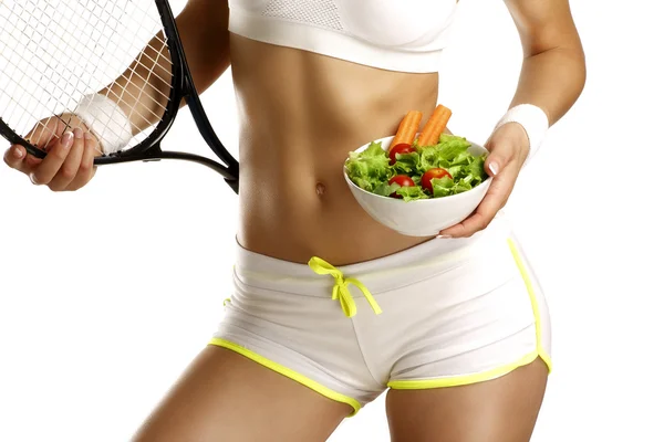 Close up of a woman measuring  hips with a salad in her hand — Stock Photo, Image