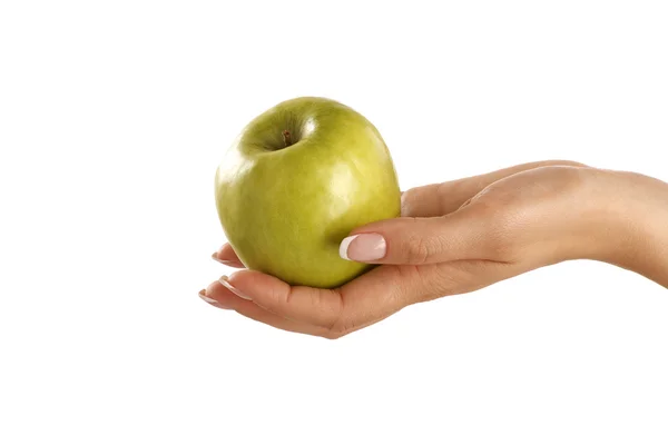 Green apple in a female beautiful hand — Stock Photo, Image