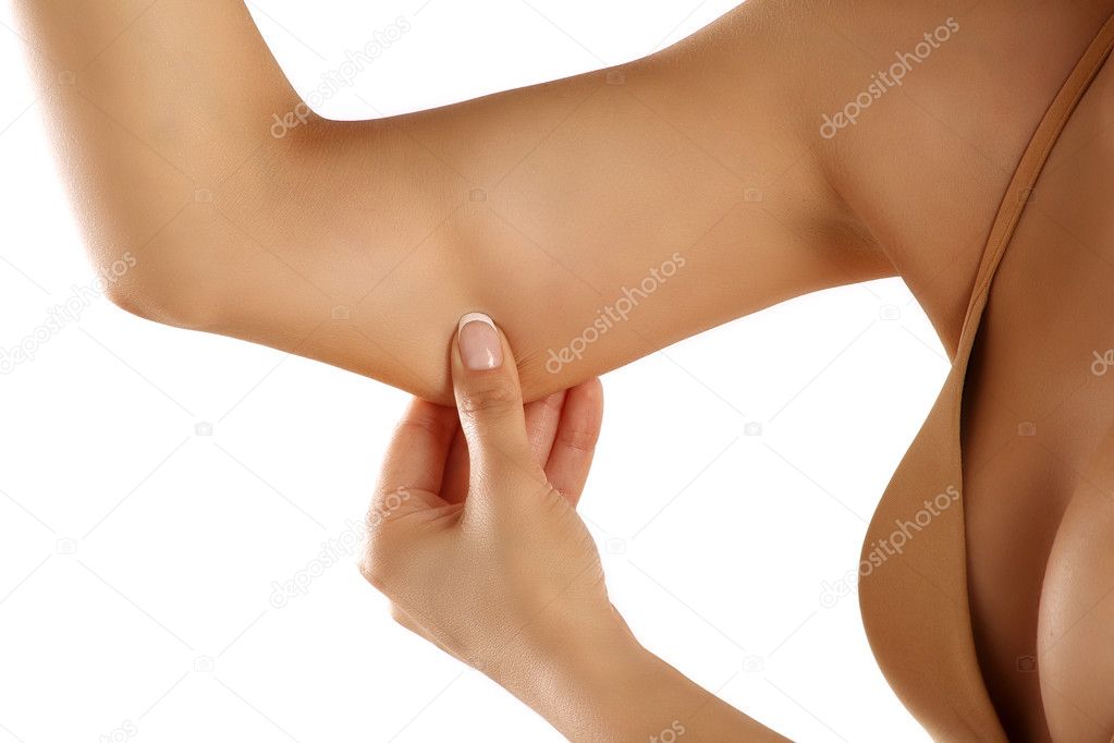 Woman checking  her skin and pinching her arm closeup 