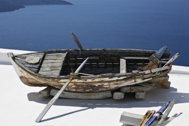 Old boat on the terrace over the sea