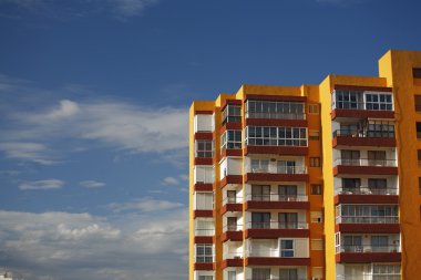 The yellow house on blue sky
