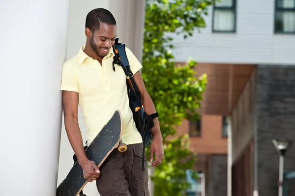 Smiling with skateboard outside — Stock Photo, Image