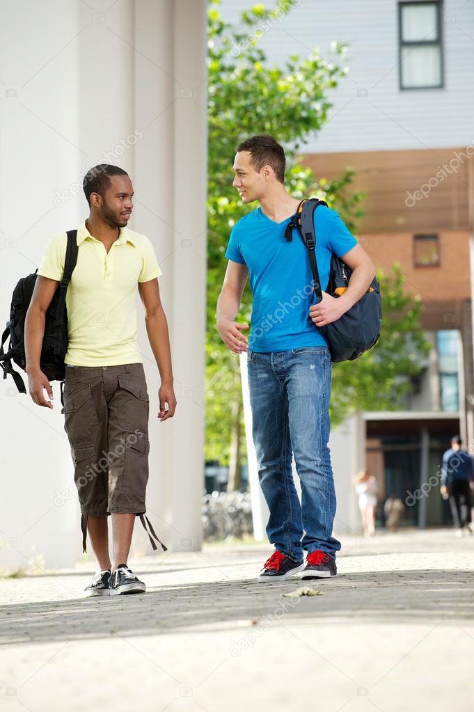 Two Students walking and talking on campus