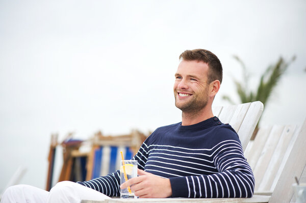 Handsome Man Sitting and Smiling Outdoors