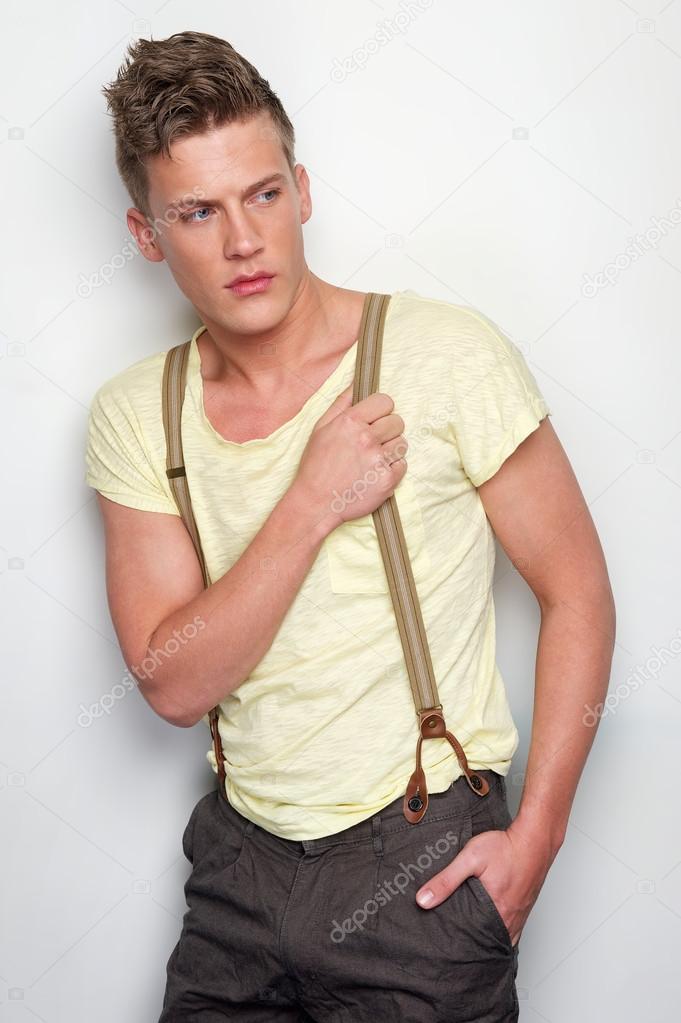 Attractive Man Holding Suspenders