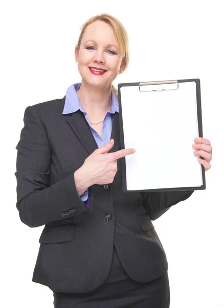 Portrait of a happy businesswoman pointing to empty sign clipboard — Stock Photo, Image