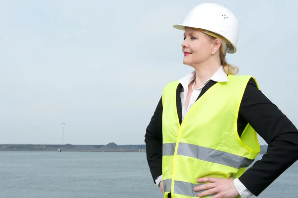 Portrait of a businesswoman in hardhat standing outdoors — Stock Photo, Image