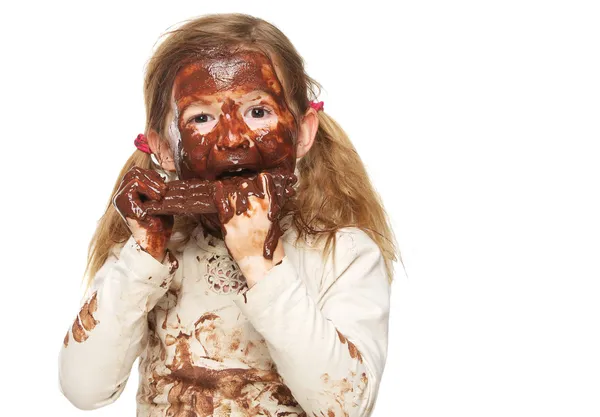 먹는 초콜릿 바와 얼굴 작은 여자의 초콜릿으로 덮여 — 스톡 사진
