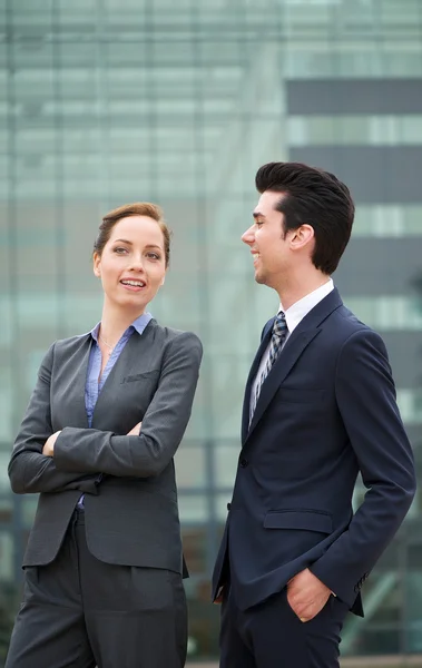 Portrait of a confident businessman and business woman smiling — Stock Photo, Image