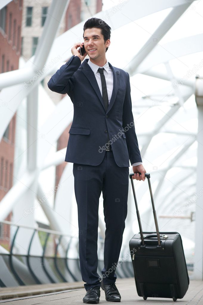 Businessman walking and talking on the phone at metro station