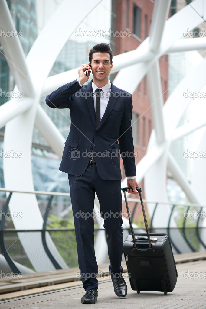 Confident businessman traveling with phone and bag
