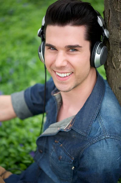 Portrait of a handsome young man smiling with headphones — Stock Photo, Image