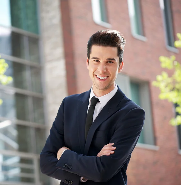 Businessman standing outside the office with arms crossed — Stock Photo, Image