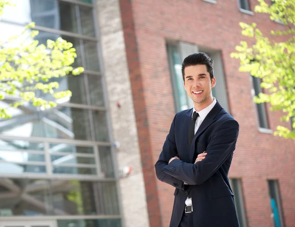 Relaxed businessman with arms crossed outdoors — Stock Photo, Image