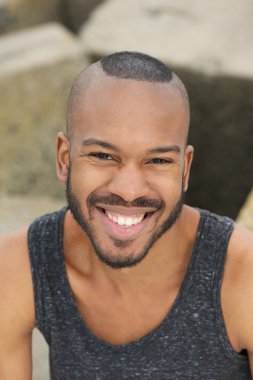 açık havada gülümseyerek mutlu bir genç adam