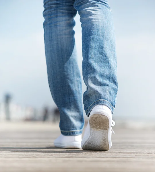 Woman walking outdoors in comfortable white shoes — Stock Photo, Image