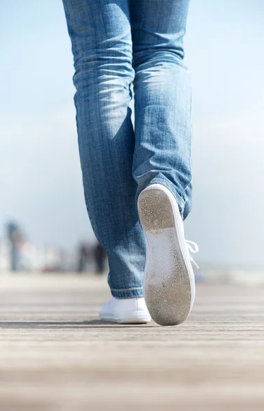 Portrait of a woman walking outdoors in comfortable white shoes — Stock Photo, Image