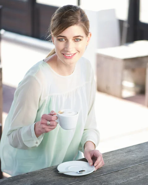 Allegro giovane signora che tiene una tazza di caffè all'aperto — Foto Stock