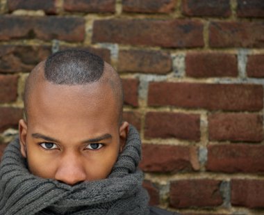 Fashion model with scarf covering face